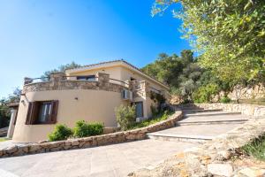 a villa with a staircase leading up to a house at Villa Panoramica Porto Istana in Porto Istana