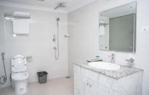 a bathroom with a sink and a toilet and a mirror at Hotel Travel INN in Kathmandu +16 photos