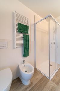 a white bathroom with a shower and a sink at Zero5.Zero5 in Lignano Sabbiadoro