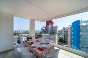 a dining room with a table and chairs and a large window at Zero5.Zero5 in Lignano Sabbiadoro