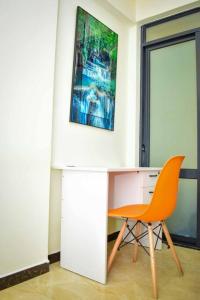 a desk and a chair in a room at The Perfect Retreat Apartment with great view. in Nairobi