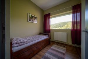 a bedroom with a bed and a large window at Parkside Vila in Odorheiu Secuiesc