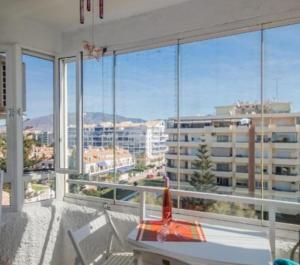 a room with a balcony with a view of a city at La duquesa in Fuengirola