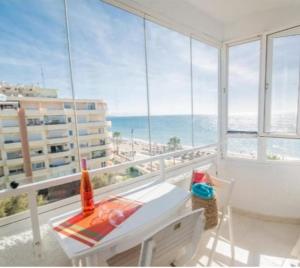 a room with a balcony with a view of the ocean at La duquesa in Fuengirola