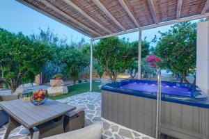a patio with a table and a swimming pool at Lemon Balm in Azolimnos