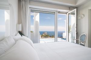 a bedroom with a bed and a view of the ocean at La Residenza Capri in Capri +37 photos