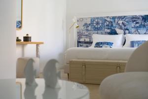 a bedroom with a bed with blue and white pillows at La Residenza Capri in Capri