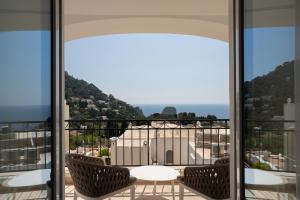 a balcony with a table and chairs and a view at La Residenza Capri in Capri