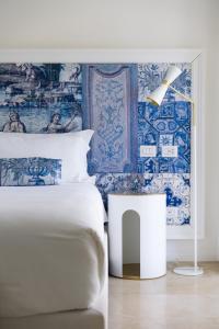 a bedroom with a bed with blue and white wallpaper at La Residenza Capri in Capri