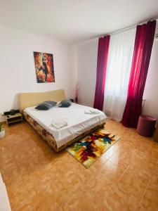 1 dormitorio con cama y alfombra en el suelo en Casa Ana, en Bucarest