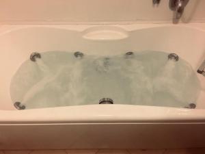a white bath tub filled with lots of water at maison flores deluxe in Bari +17 photos