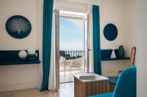 a living room with a door open to a balcony at La Residenza Capri in Capri