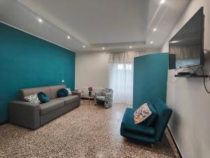 a living room with a couch and a flat screen tv at Al Castello in Rocca Sinibalda