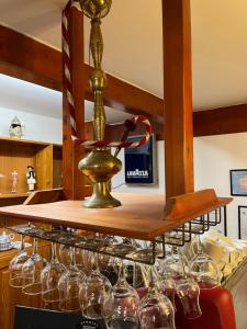 a bunch of wine glasses on a shelf at Hotel-Restaurant Siesta Balea in Cumpăna