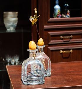 two glass bottles sitting on top of a table at Casa Di Pietra in Fethiye