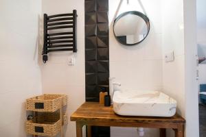 a room with a wooden table with a mirror and a stool at Uroczy Apartament Muszynka in Muszynka +4 photos