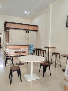 a classroom with tables and chairs and a chalkboard at GRAND TOBA HOTEL in Balige