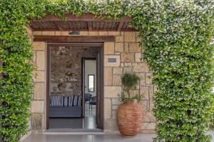 an entrance to a building with a large vase at Tramonto Suites in Xi
