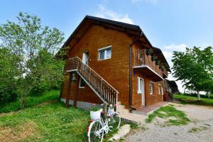 a bike parked in front of a house at Apartments Laura in Rakovica