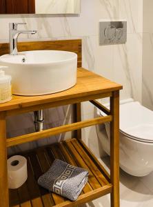 a bathroom with a sink and a toilet at Palazzo Arhontiko Apartments in Agios Nikolaos