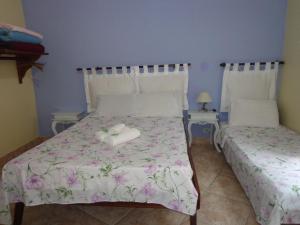 Postel nebo postele na pokoji v ubytování Pousada da Rose Paraty