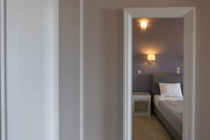 a small bedroom with a bed and a small room at Tramonto Suites in Xi
