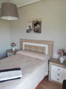 a bedroom with two beds and a picture on the wall at Apartamento Teatinos Málaga in Málaga