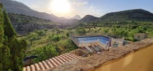 a house with a view of a valley with mountains at Casa Pura Vida in Relleu