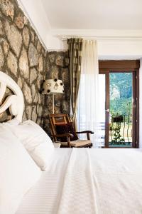 Кровать или кровати в номере Casa Di Pietra