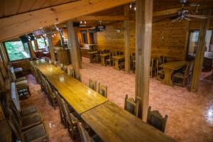 an overhead view of a restaurant with wooden tables and chairs at 4 Évszak Völgyhotel in Mátrafüred