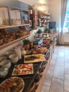a buffet line with a lot of plates of food at Hotel Kaiserhof in Goslar