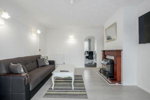 a living room with a couch and a coffee table at Tms Lovely 3 Bed House-Tilbury-Free parking in Tilbury