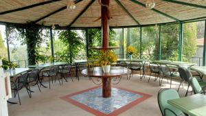 a patio with tables and chairs in a building at Casa Gialla B&B in Lipari