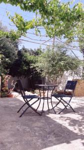 a table and two chairs sitting under a tree at Malia Fountain House in Famagusta