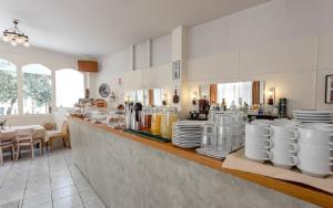 a kitchen with a counter with plates on it at Adam's Hotel in Athens