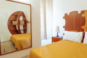 a hotel room with two beds and a mirror at Relax in Vieste