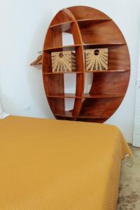 a circular mirror on a wall next to a bed at Relax in Vieste