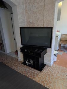 een flatscreen-tv op een zwarte standaard in een woonkamer bij Dobar san in Zagreb