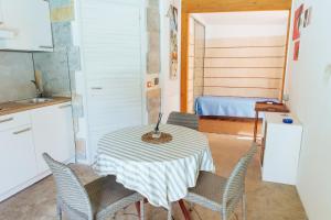 a kitchen with a table with chairs and a bed at Relax in Vieste
