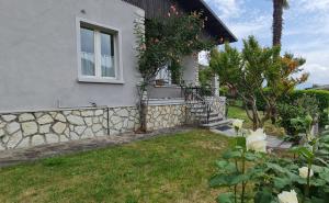 a house with a stone wall and a window at Hotel Gallo in Tignale