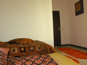 a bedroom with a bed with a pillow on it at Casa Rustica Apart & Rooms in Cîmpineanca