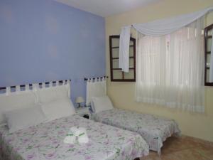 Postel nebo postele na pokoji v ubytování Pousada da Rose Paraty