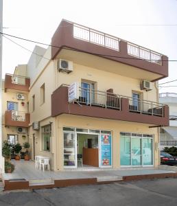 a building with a balcony on top of it at Rania Studios in Gouves