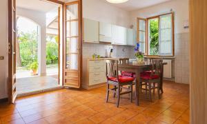 a kitchen with a table and chairs and a kitchen with a door at AmareNumana in Numana