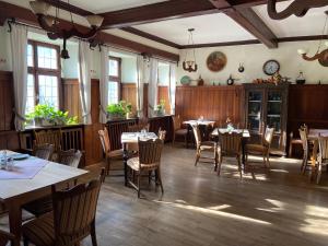 un restaurante con mesas y sillas en una habitación en Pension Main-Art en Mainstockheim