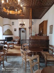 a dining room with tables and chairs and a chandelier at ΘΕΤΙΣ in Vyzitsa