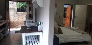 a bedroom with a bed and a table with a blender at Zeezicht Holiday Guest Unit in Franskraal