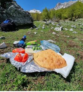 chleb pita i warzywa siedzące na polu w obiekcie Guest house Hyrmet Demushi w mieście Valbonë