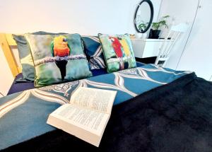 a book on a bed with a bird on it at Apartament nad Jeziorem in Olecko