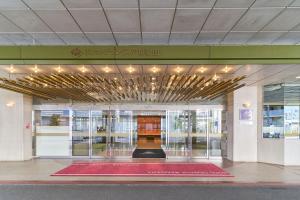 a lobby with a red rug in front of a building at Hotel Granvia Wakayama in Wakayama